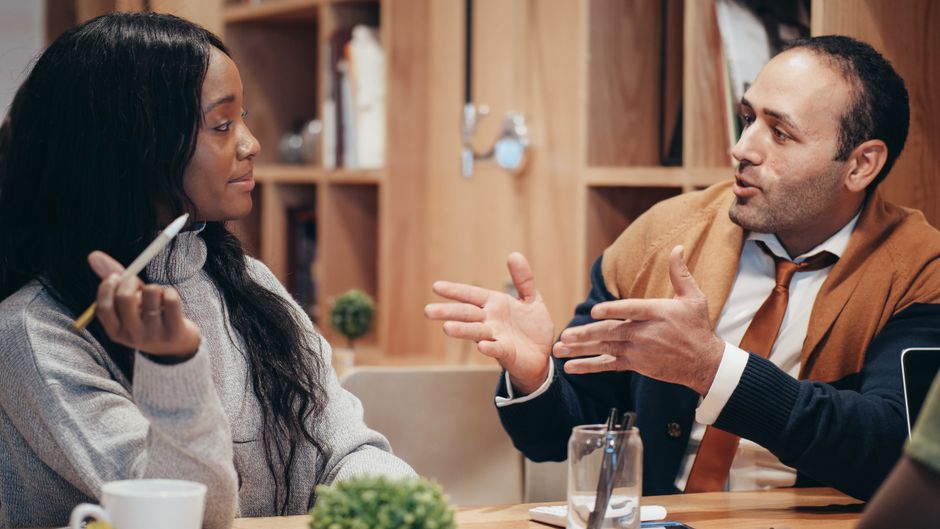 Colleagues sit together during an office discussion.