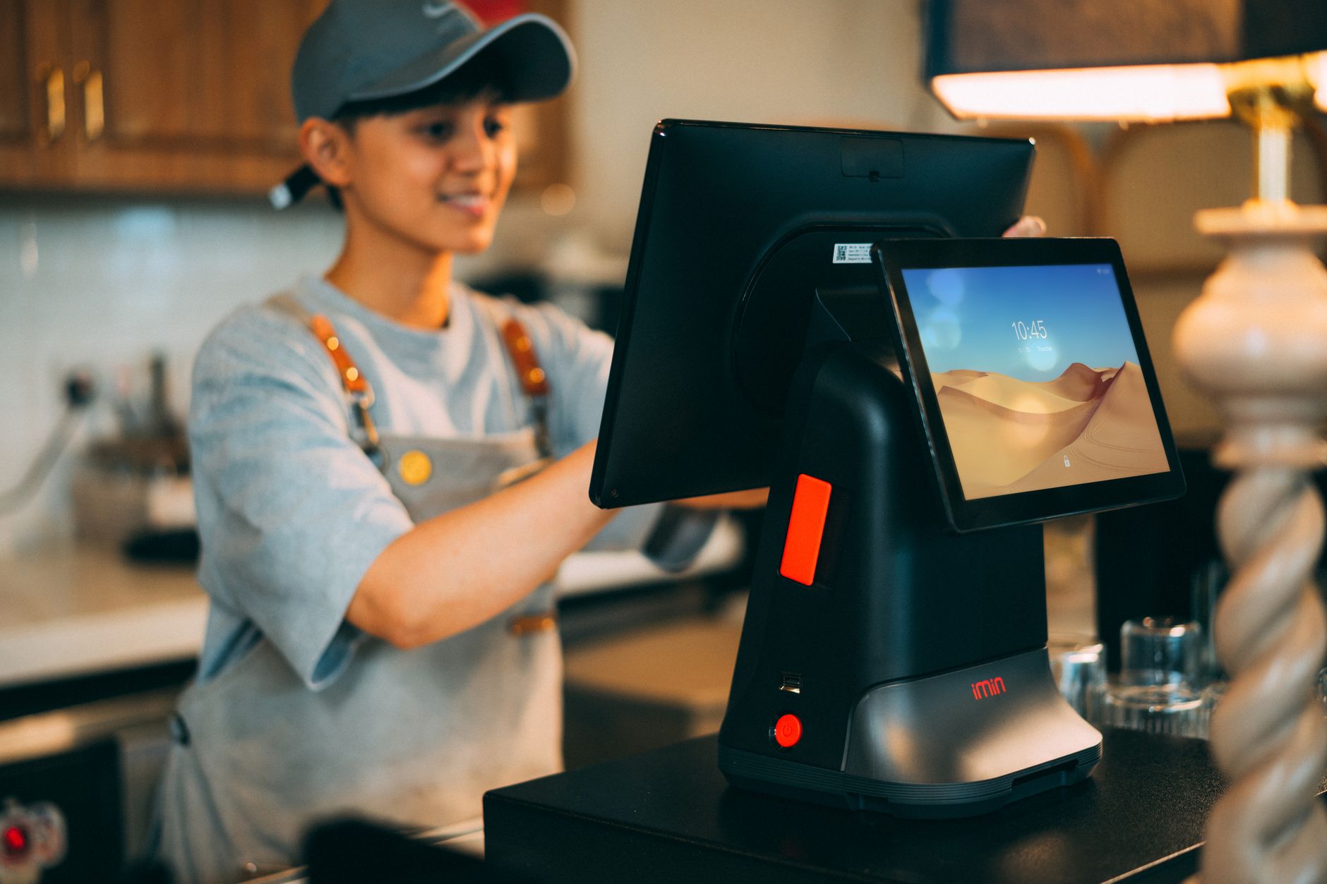 A retail checkout counter with a tablet point-of-sale terminal, card reader and receipt printer, with no customer in line