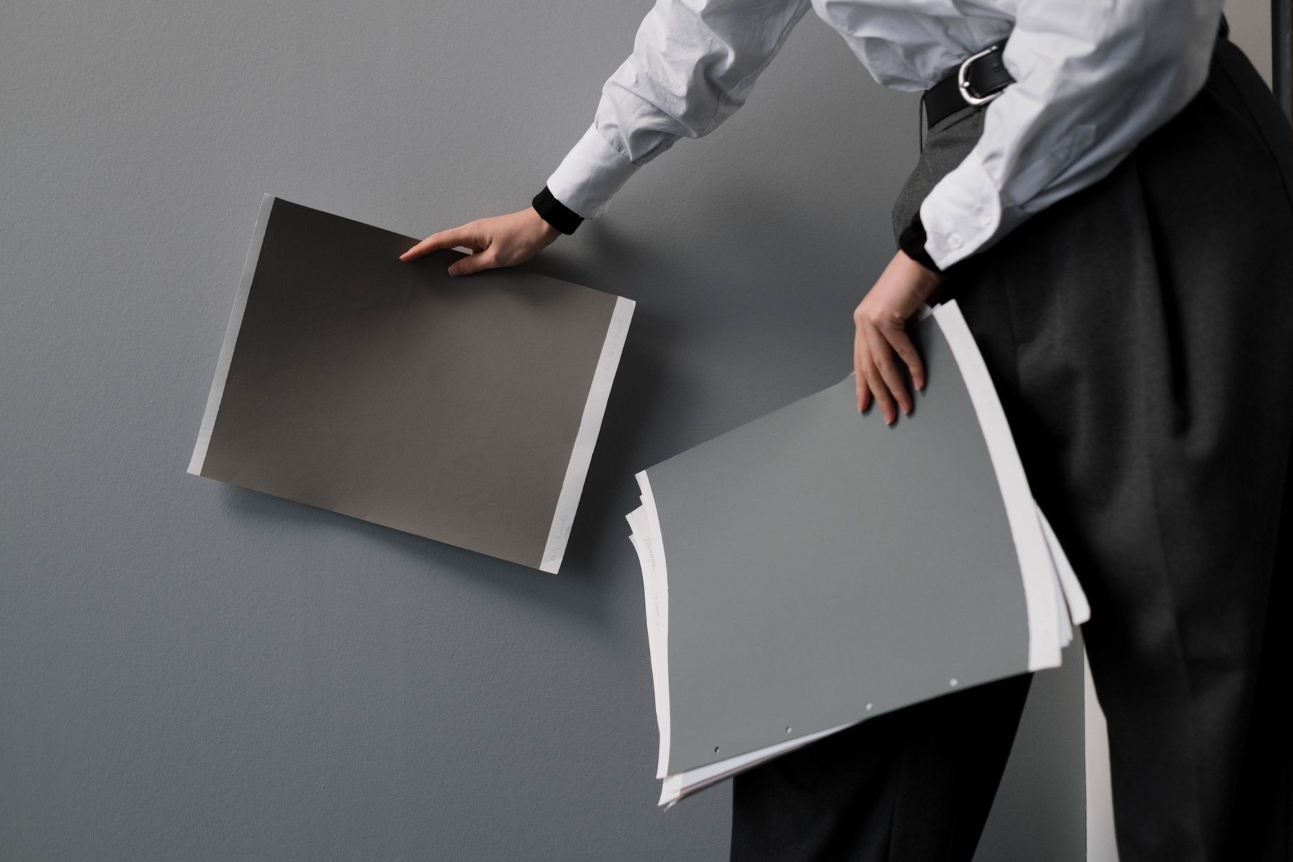A person holding design samples while planning an interior project indoors.