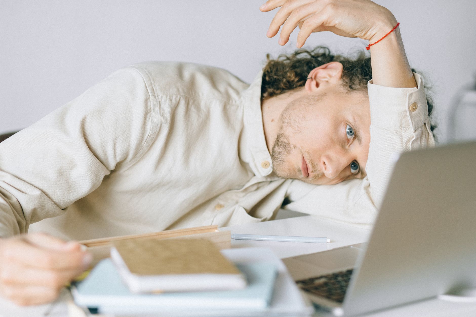A tired person sitting at a desk after sustained work
