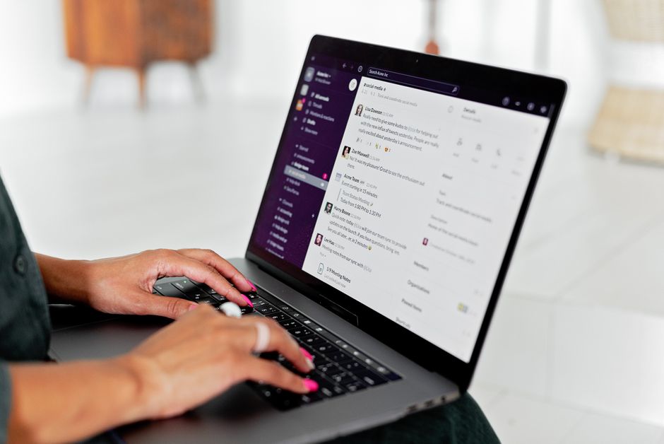 A professional writes a careful message on a laptop.