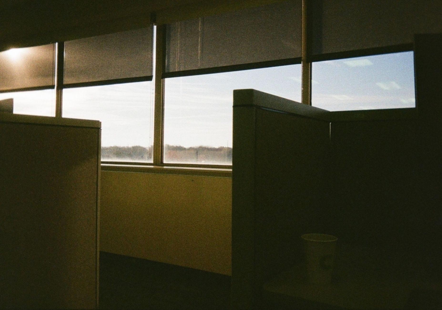 An empty morning desk with a single notebook open, phone face-down beside it