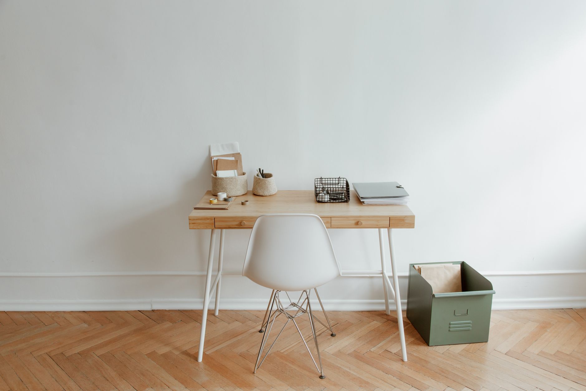 A person sitting across a small table from an interviewer in a bright office, hands folded, mid-conversation