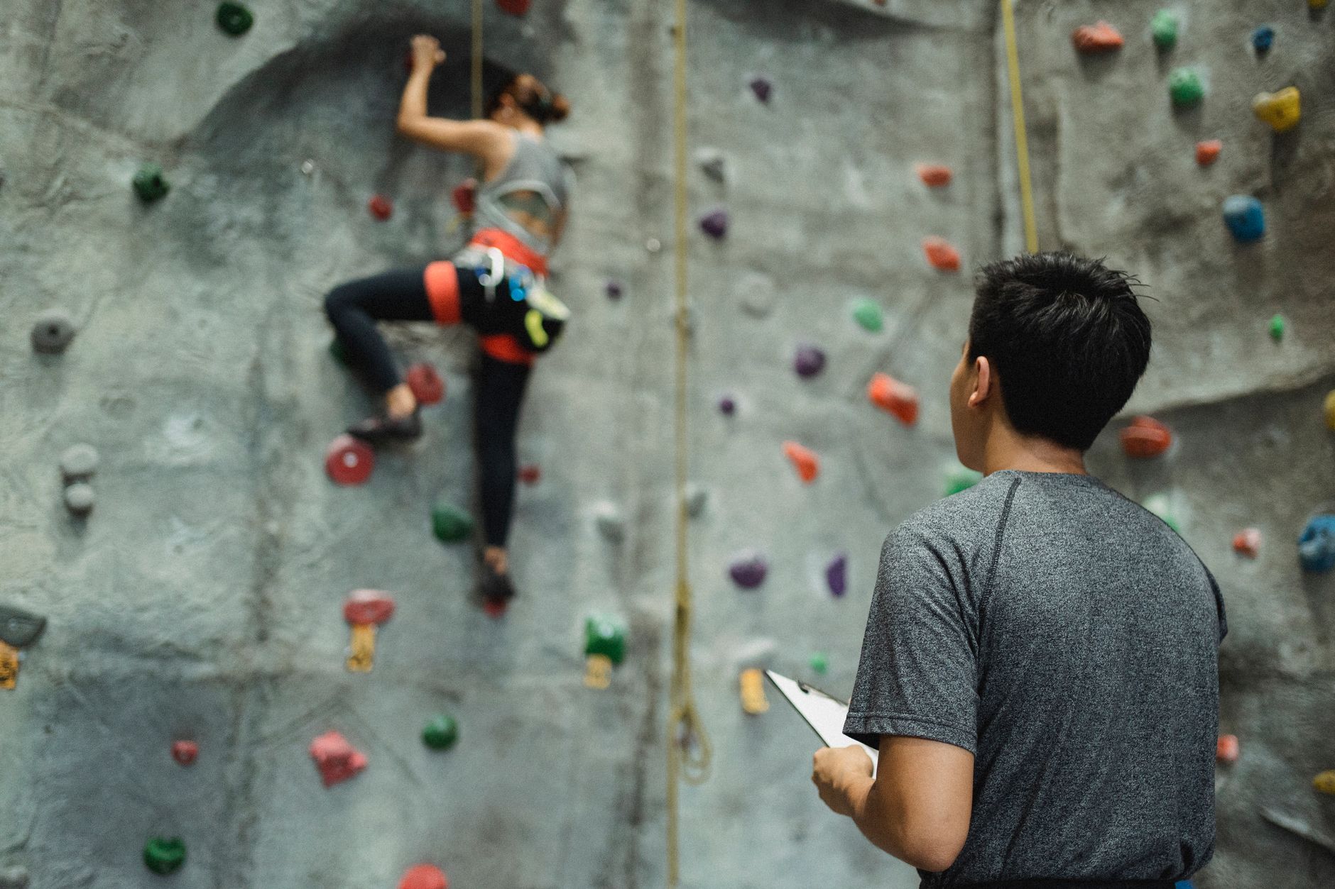 A person taking one controlled step into a difficult challenge rather than making a reckless leap