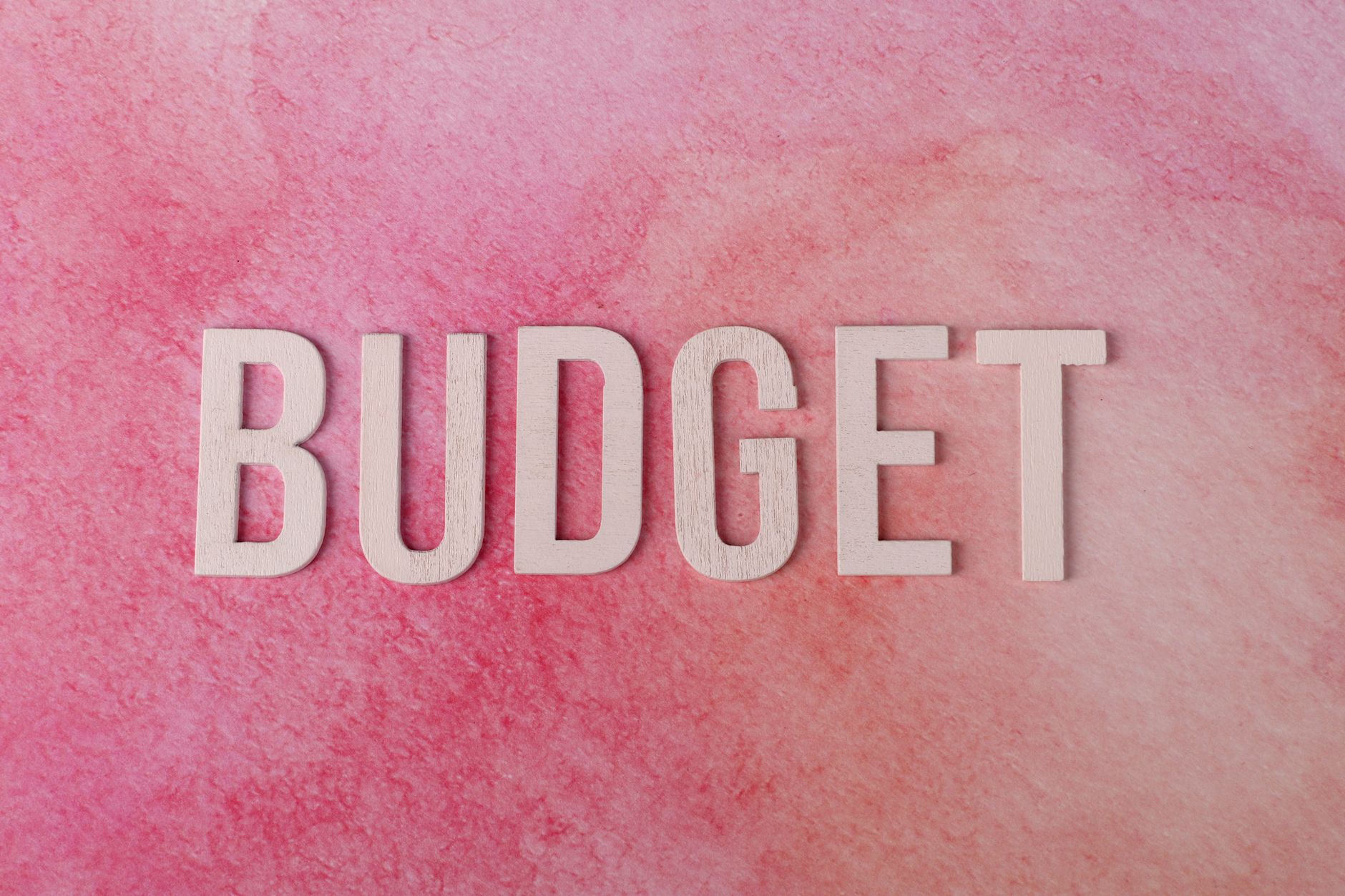 The word budget arranged on a textured background.