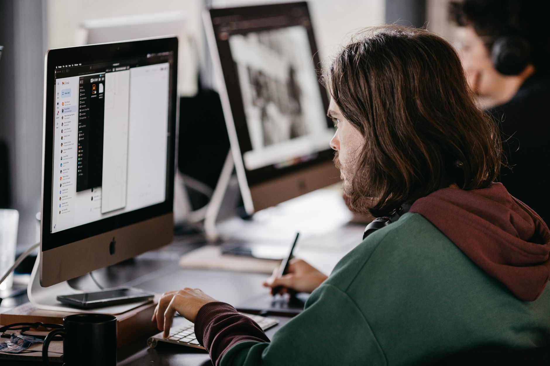A person working with deep concentration at a desktop computer