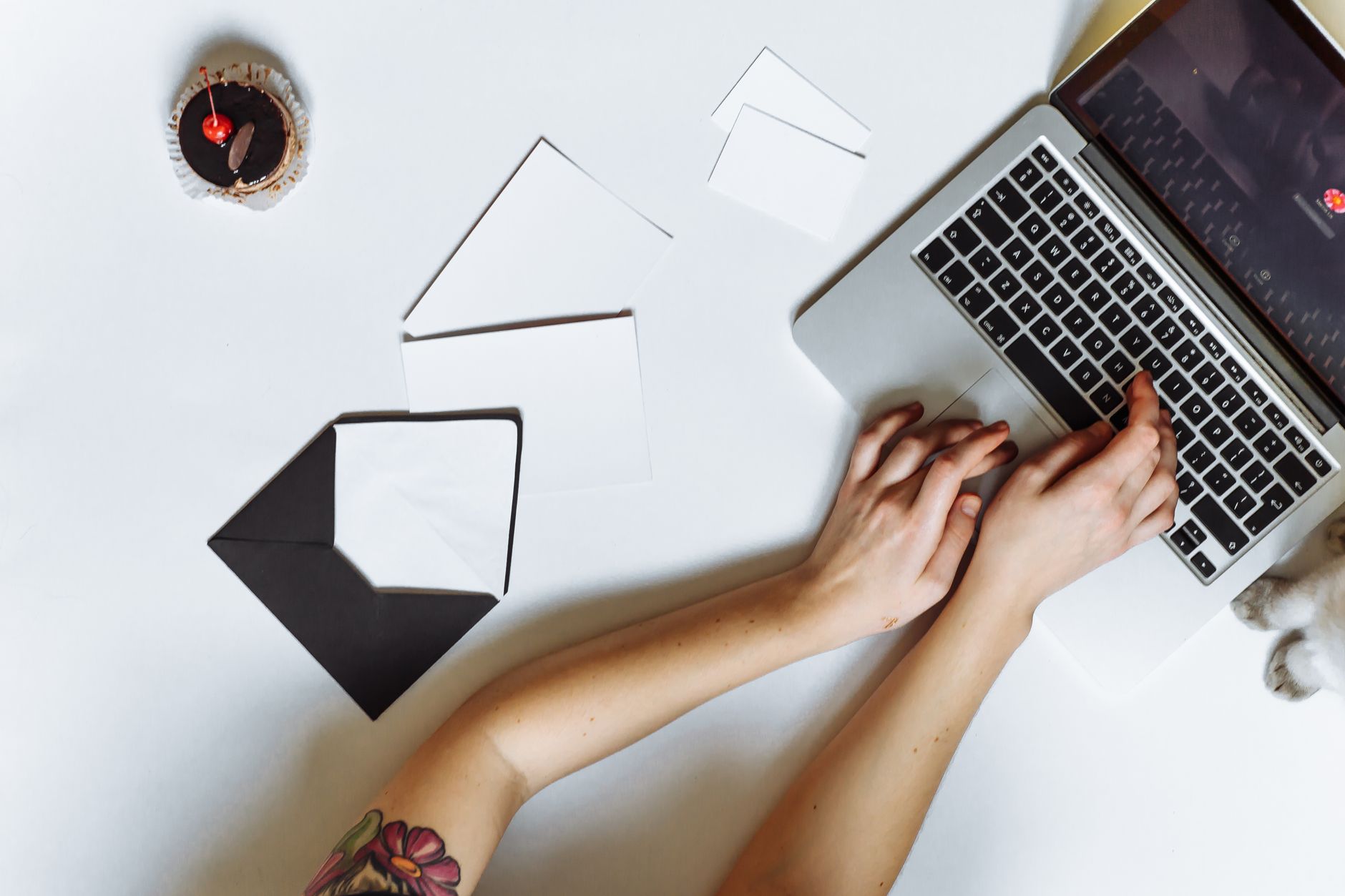 A job seeker reviewing a printed cover letter and resume at a desk