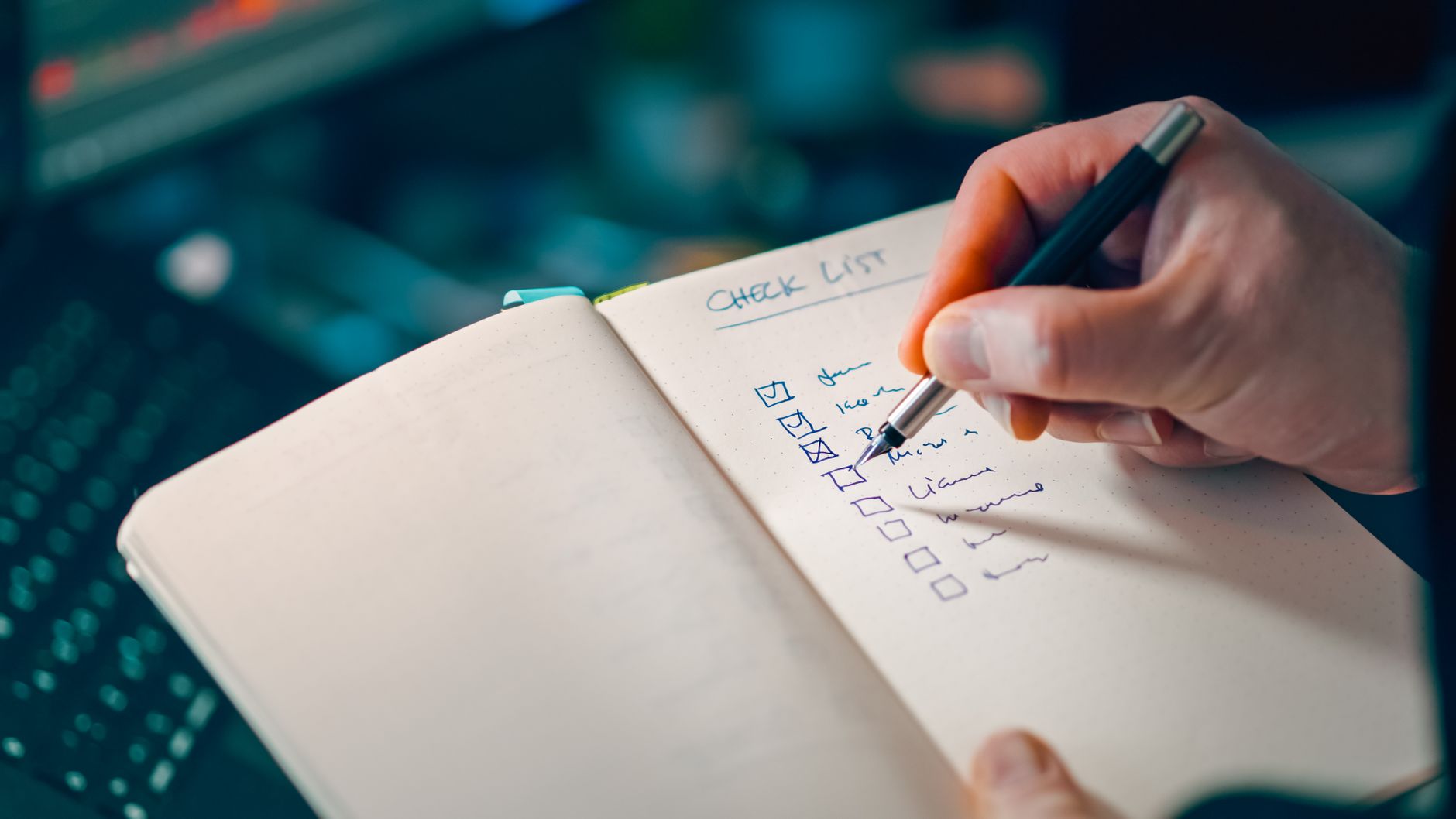 A single sticky note with a short list, sitting alone on an otherwise clear desk