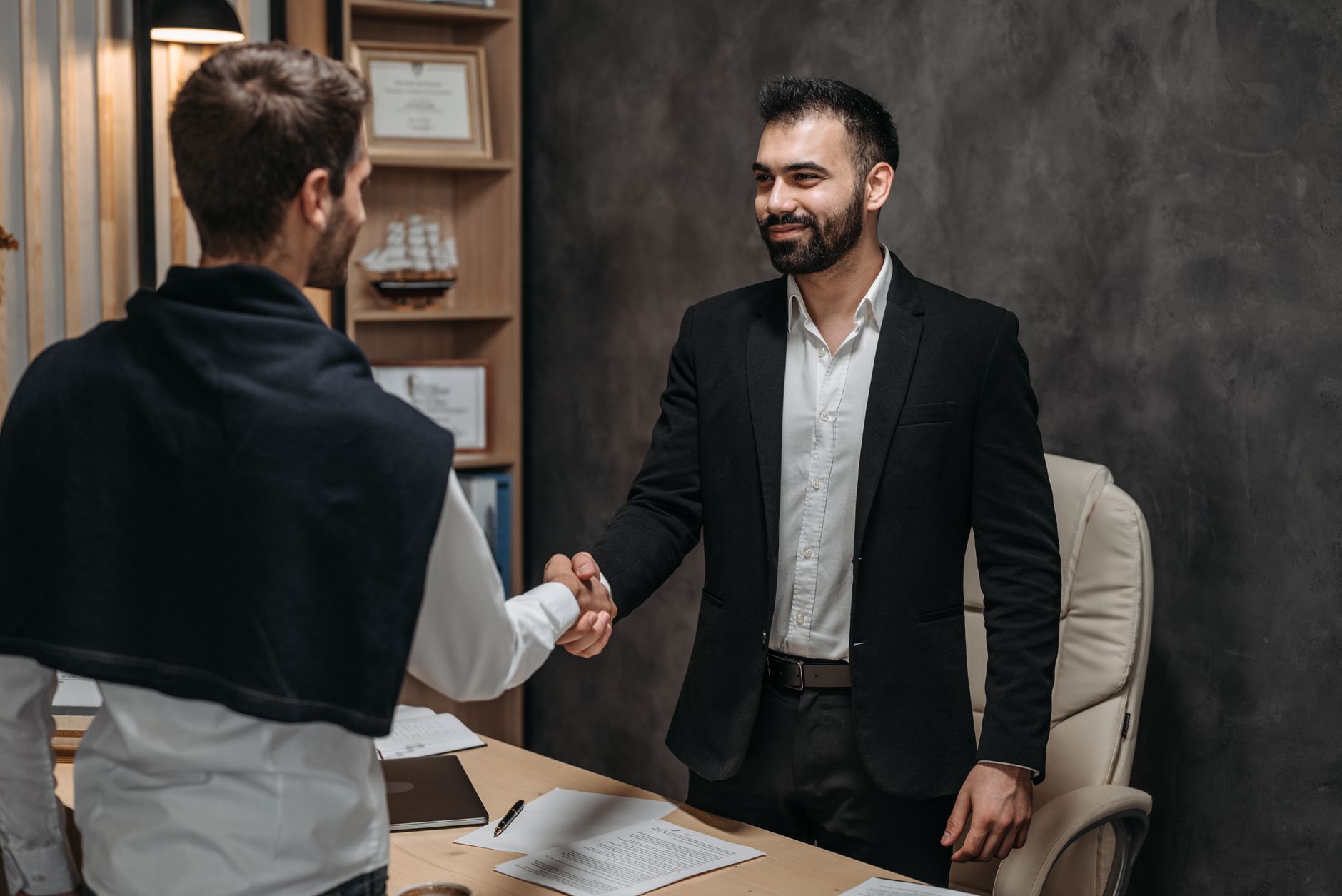 A recruiter and candidate mid-conversation across a table during a job interview