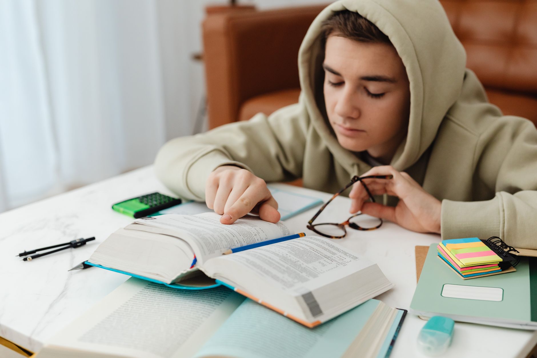 An overhead flat-lay of a study desk with a notebook, coffee, and a timer