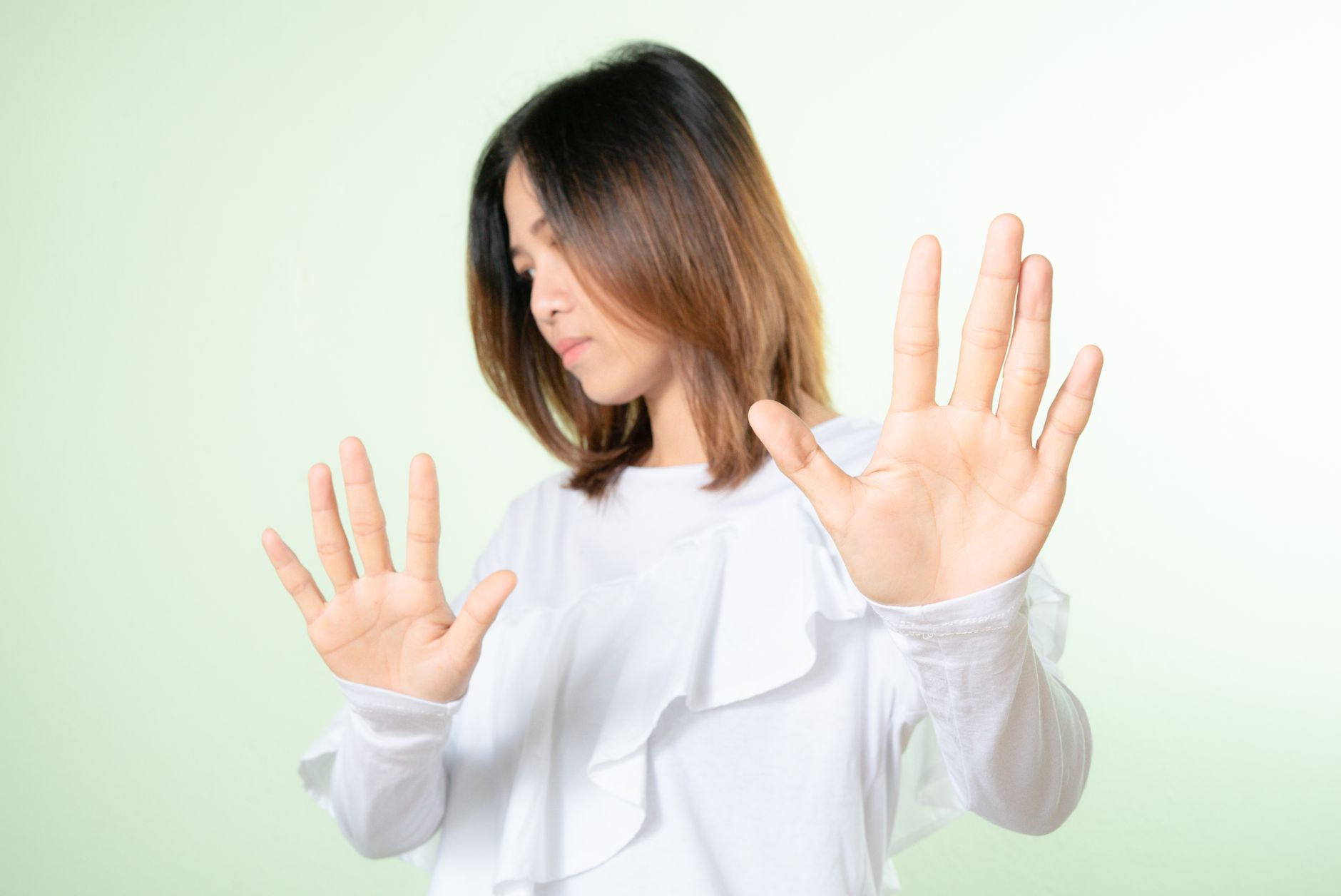 A person at a desk pausing with a phone in hand before answering a message