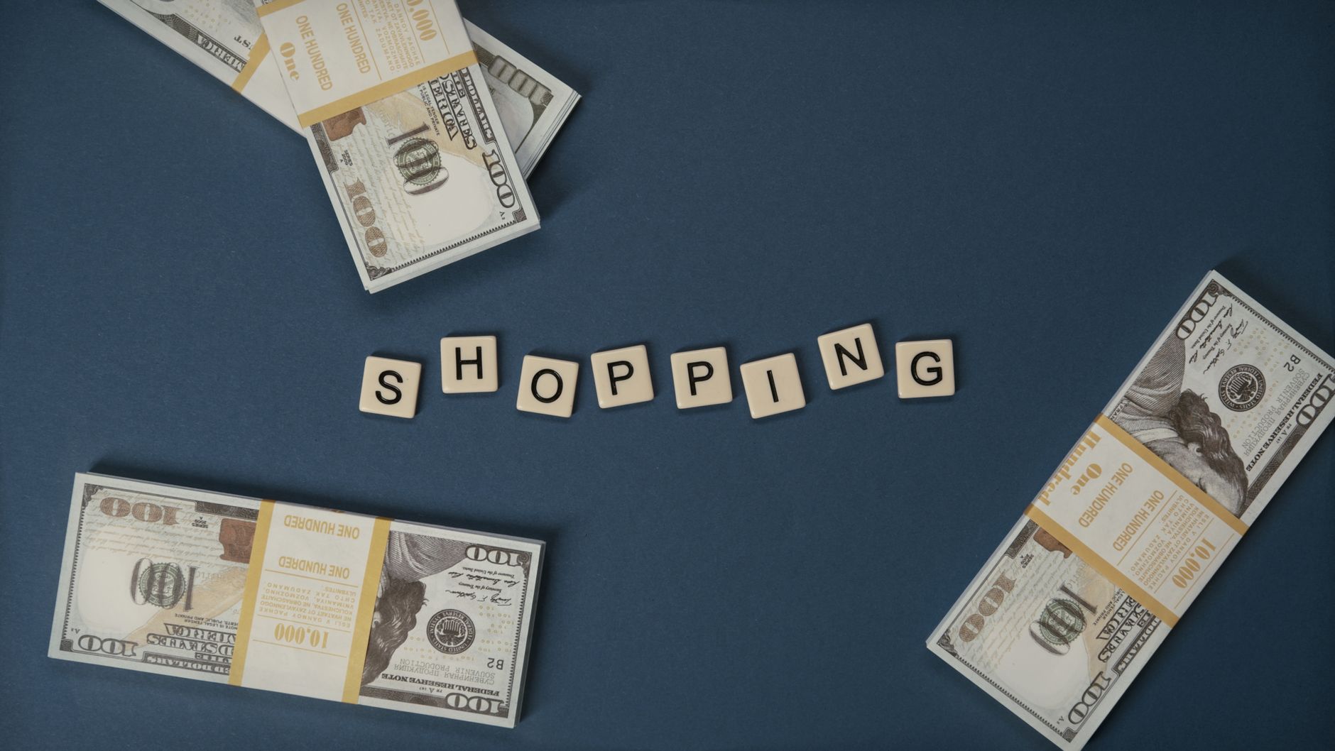 US dollar bills arranged around the word shopping