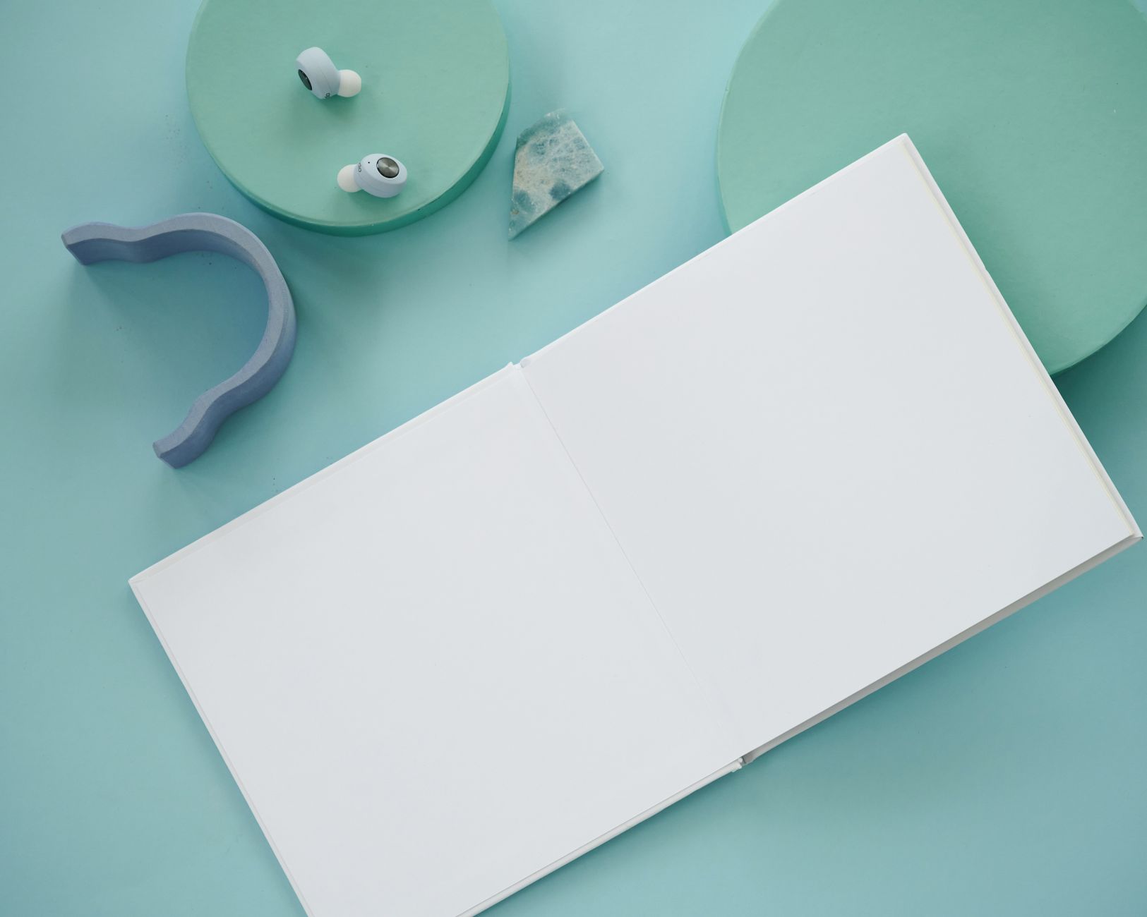 Open book arranged with simple pastel objects