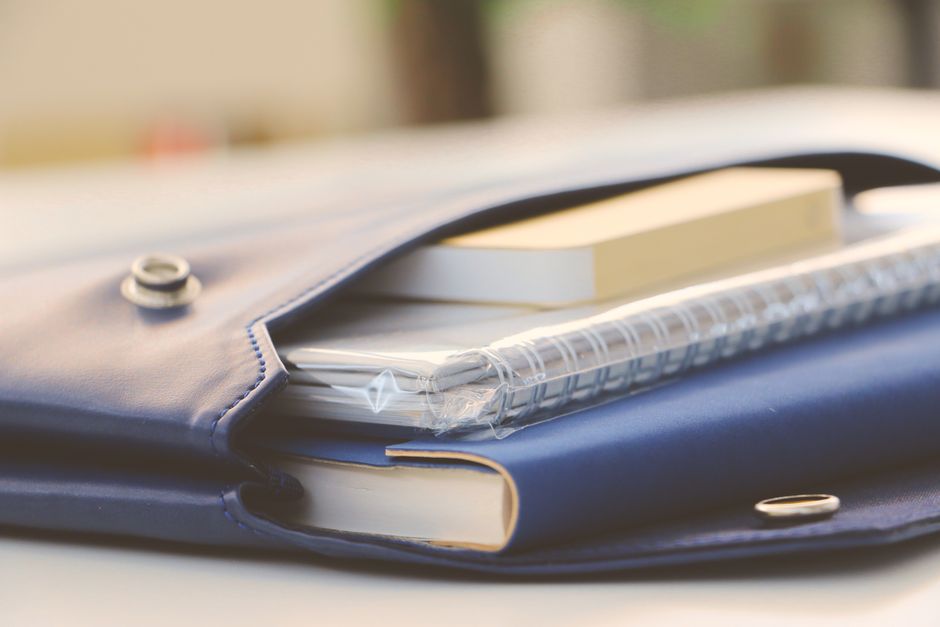 Notebooks organized inside a blue portfolio.