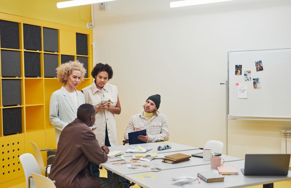 An office team reviewing work together at a meeting table.