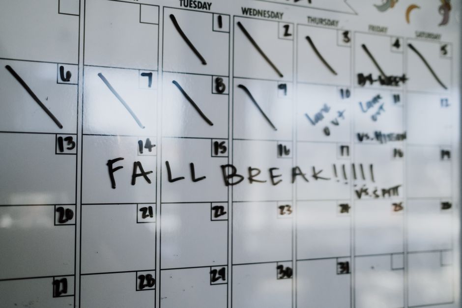 Close-up of a whiteboard calendar with 'FALL BREAK' written in bold letters.