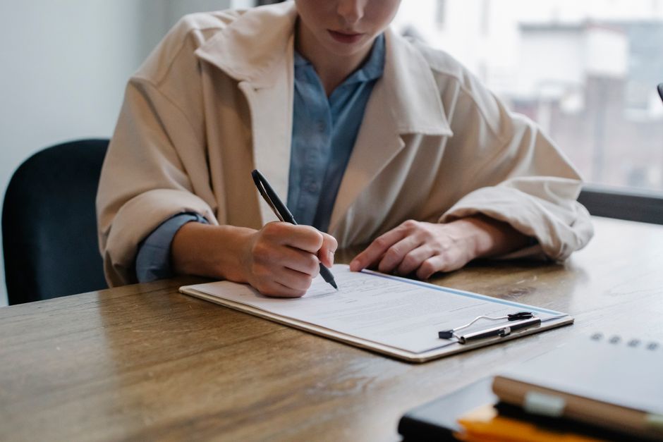 A candidate completes application materials during a hiring conversation.