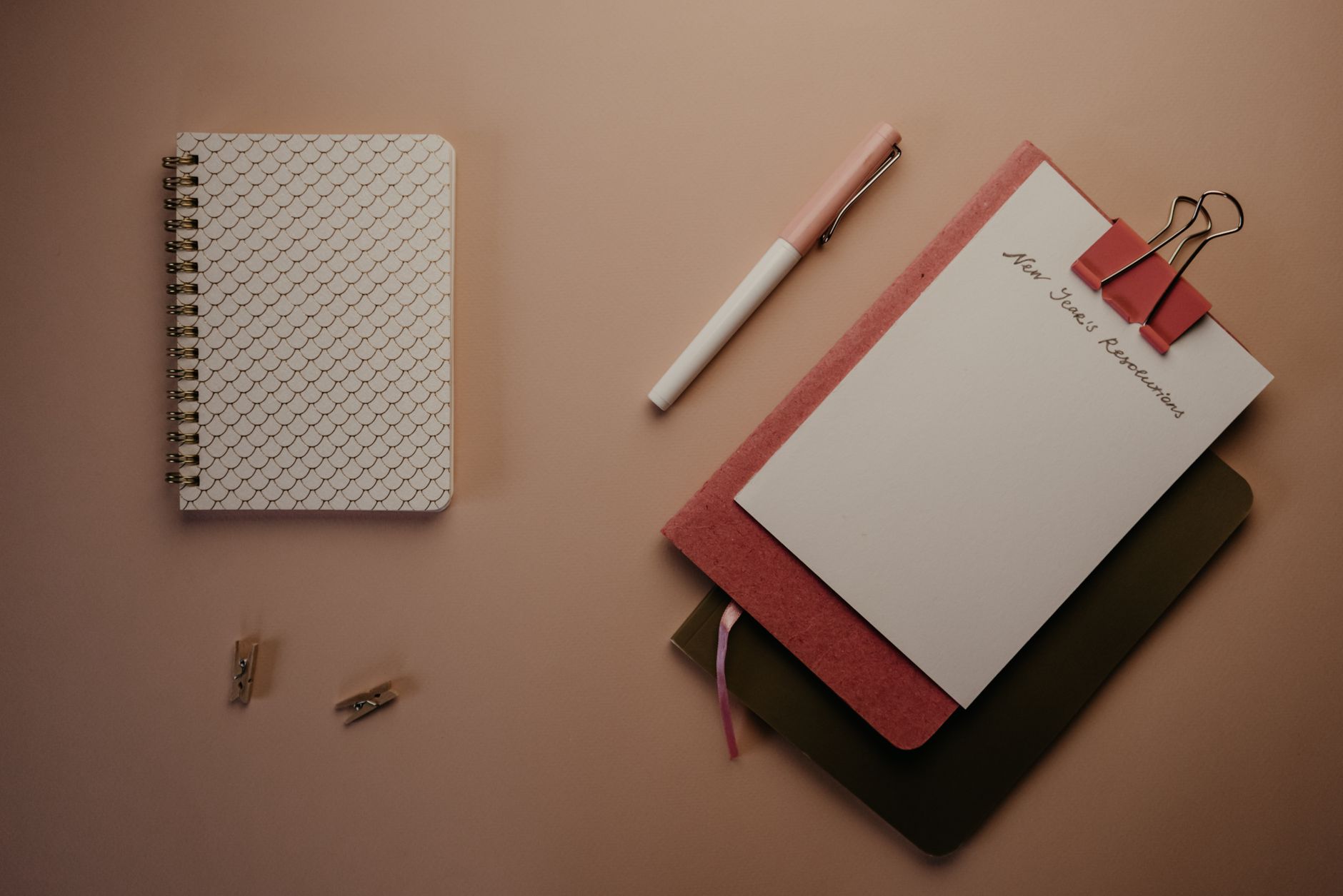Planning notebooks and a pen in an organized flat lay.