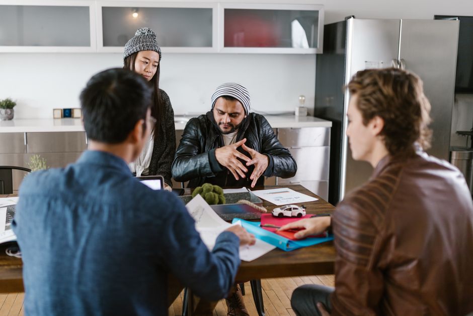 Colleagues brainstorming around a table in a modern office.