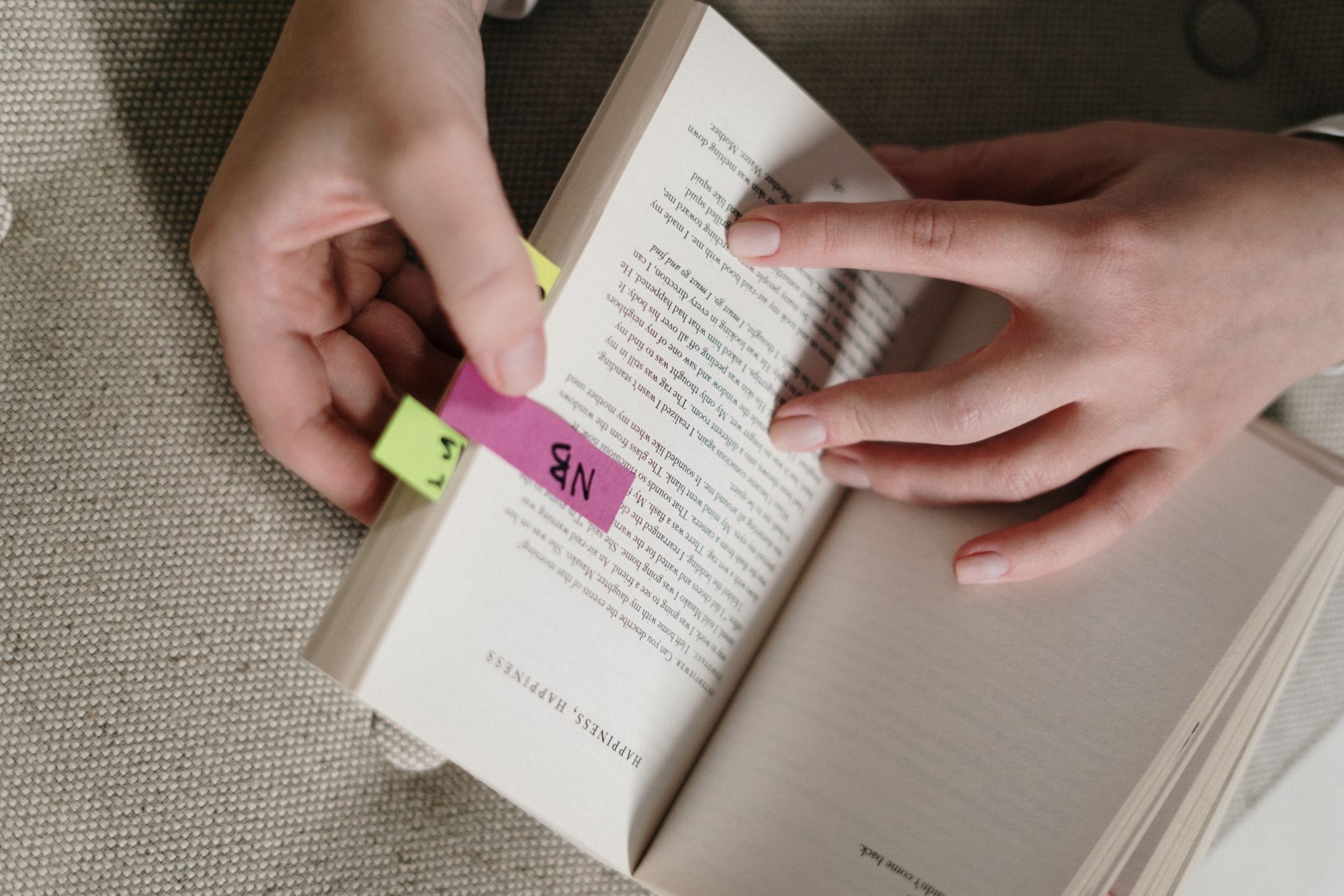A stack of business books beside a single page of handwritten notes