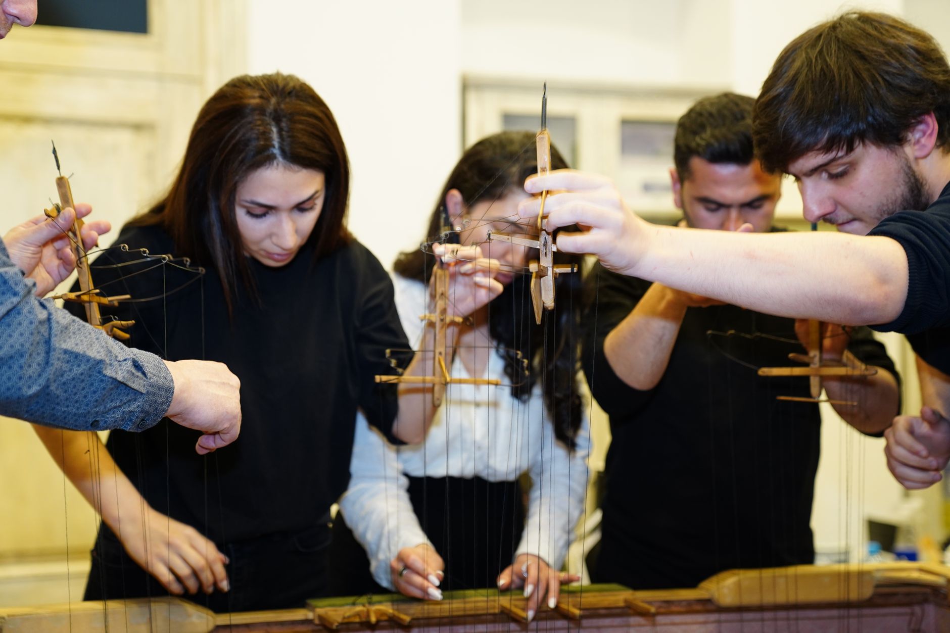 People concentrating together in a hands-on workshop