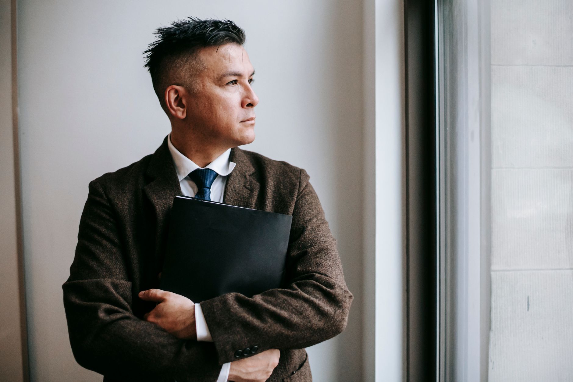 A capable professional sitting alone with visible doubt despite a record of completed work